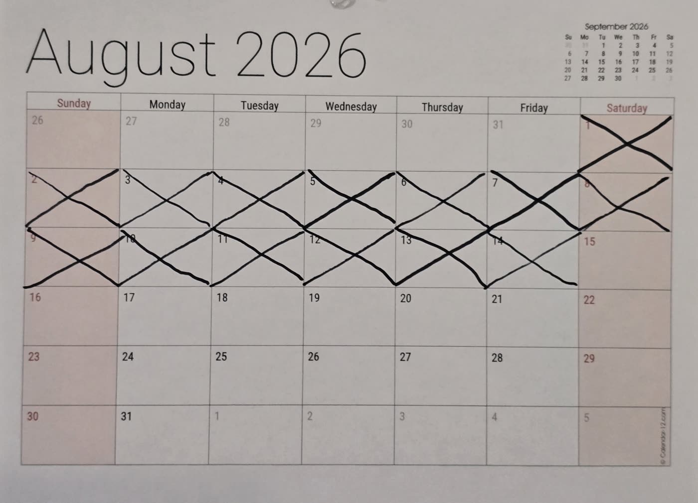 The wall calendar with all fourteen days of August crossed off