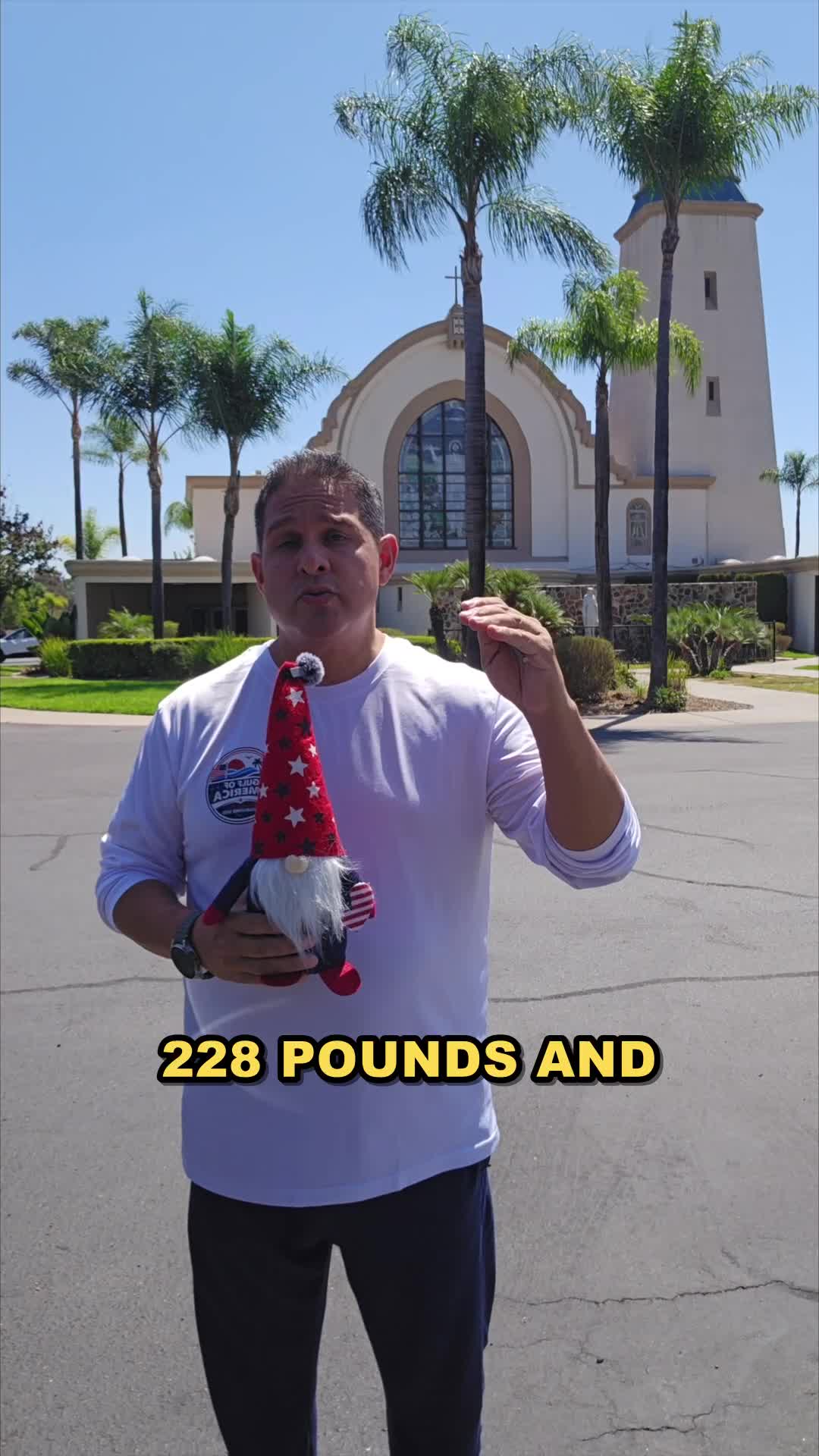 John on day 14 of the 90 day water fast, outside in front of the mission church with the gnome